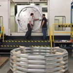 Engineer and CNC Machinist discussing tight tolerances on some large machined aluminum parts